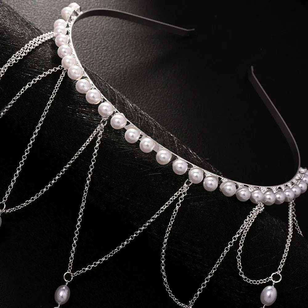 Women's decorative hair chain with pearl bead and tassel in gold or silver electroplated finish.