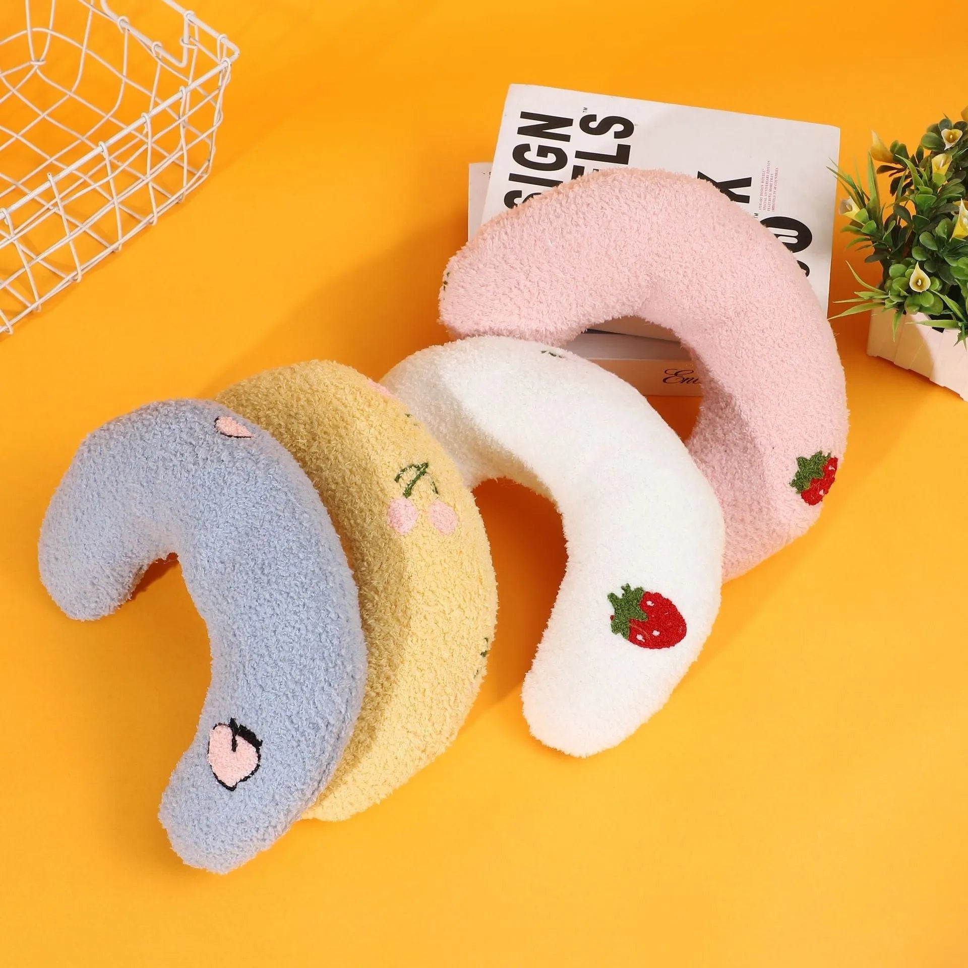 Blue half moon U-shaped cloth pillow with cartoon pattern for dogs and cats to sleep on.