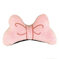 A soft plush bow tie helmet decoration shown in red, peach pink, and rose pink colours.