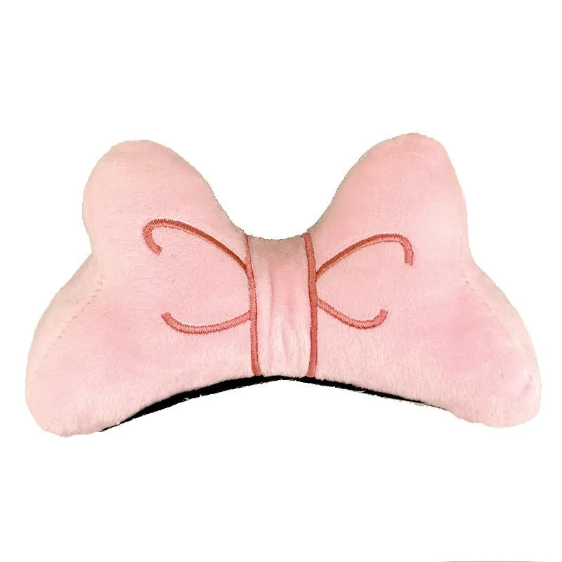 A soft plush bow tie helmet decoration shown in red, peach pink, and rose pink colours.
