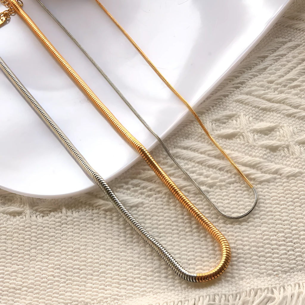 Golden tone stainless steel snake bones chain necklace with 3mm thickness and geometric pattern