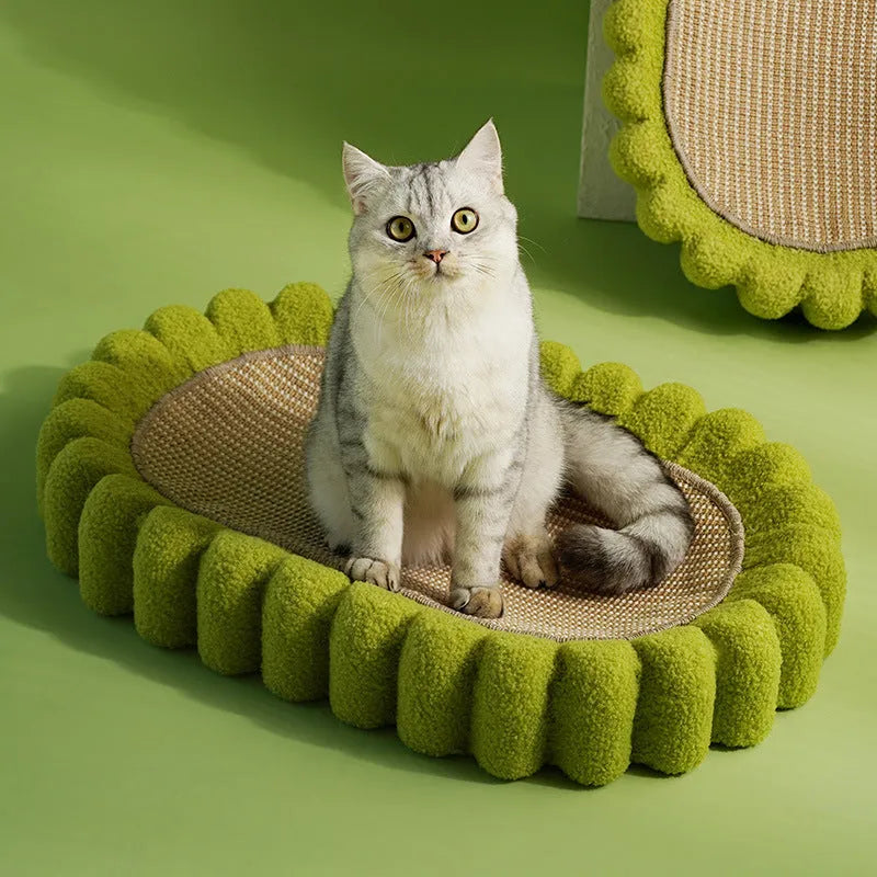 Green oval-shaped sisal cat scratching pad lounge bed on a floor.