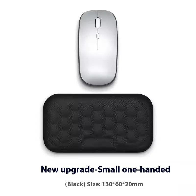 Memory foam mouse wrist pad with silicone bottom in black cloth cover on computer desk