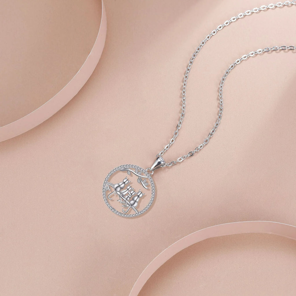 Copper necklace with electroplated four kitten pendant and cross chain.
