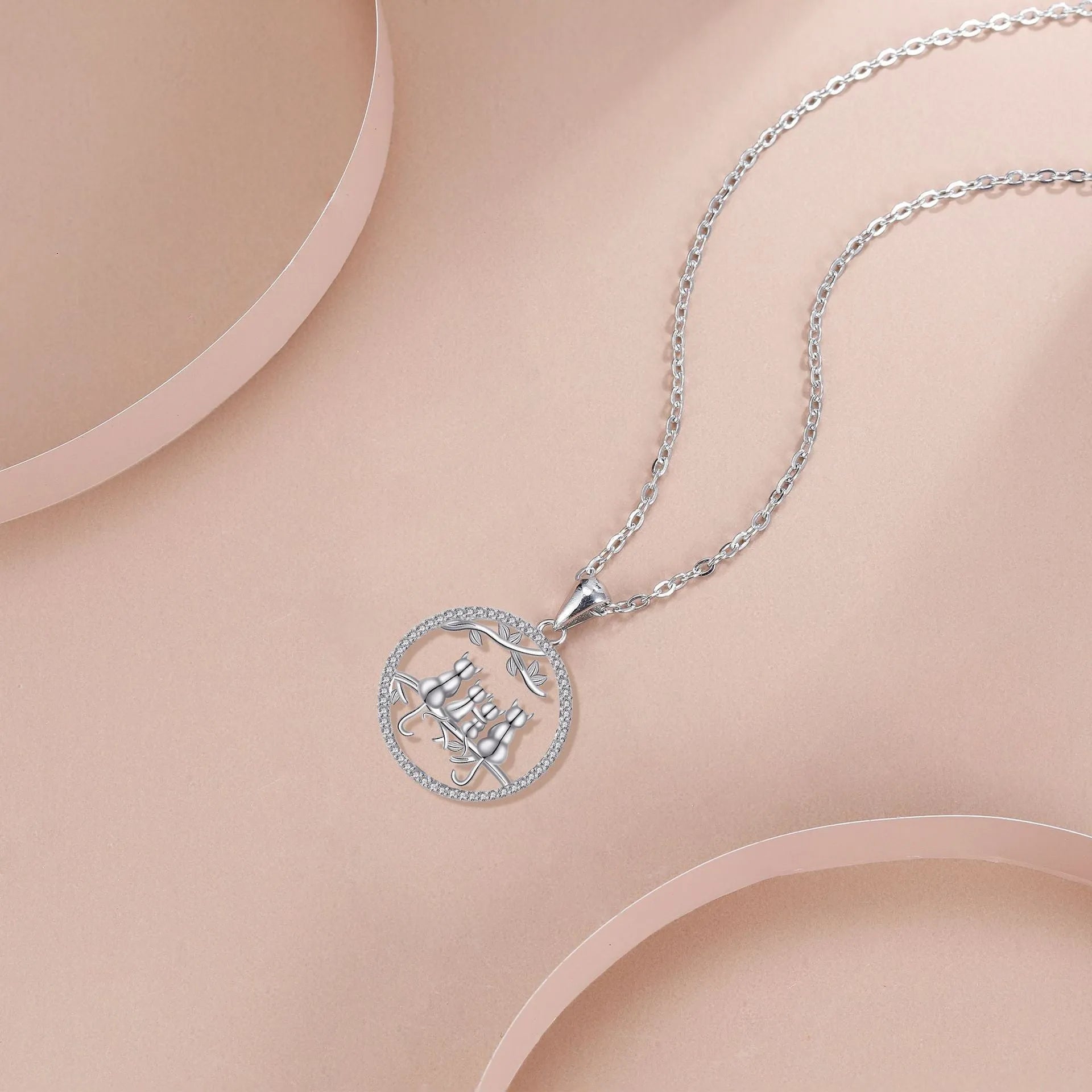 Copper necklace with electroplated four kitten pendant and cross chain.