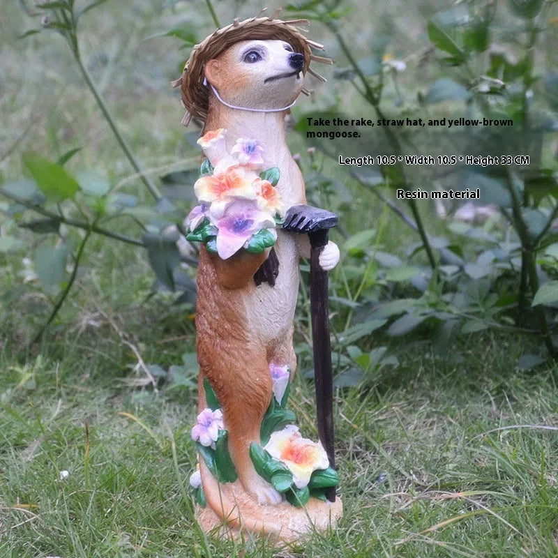 Yellow brown synthetic resin mongoose garden ornament wearing a straw hat and holding a rake or shovel for bonsai decoration