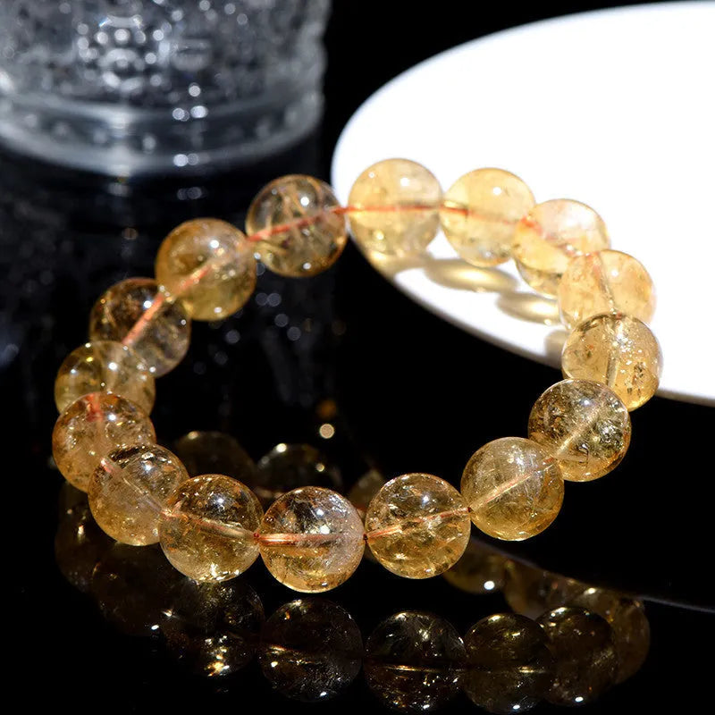 Natural yellow citrine gemstone bracelet showing geometric cut beads on a string.