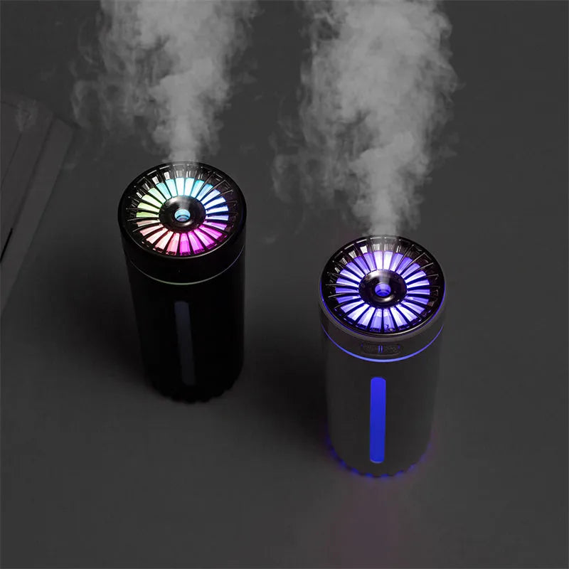 Black portable USB humidifier with colourful LED lights, shown next to a USB cable, suitable for car cup holders.
