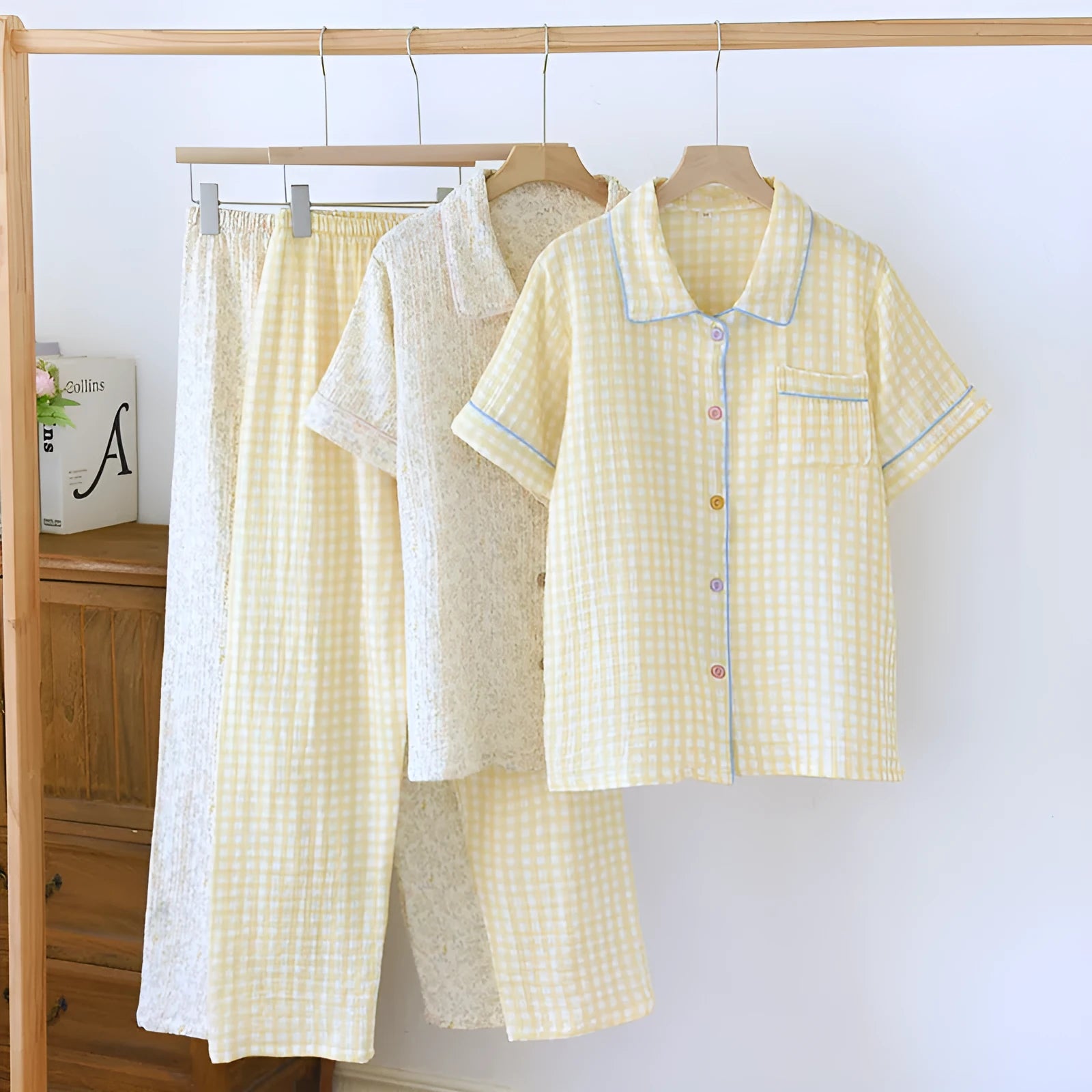 Women's loose-fit cotton gauze pyjama set with short sleeves and trousers in a floral or plaid pattern.