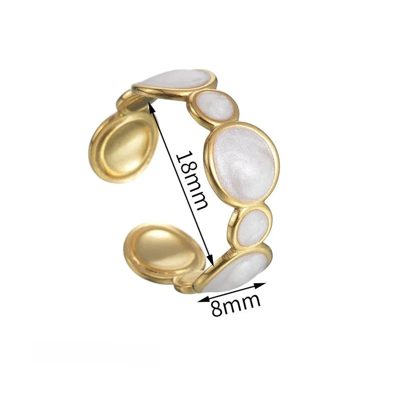 Adjustable geometric stainless steel ring for women on a plain background.