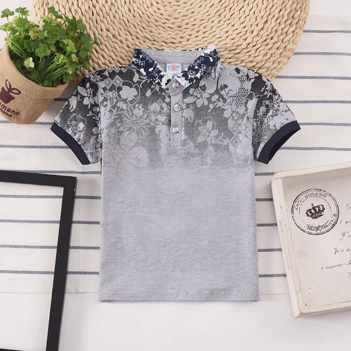 Boys' short sleeve cotton shirt in a solid colour with a lapel collar, shown on a hanger.