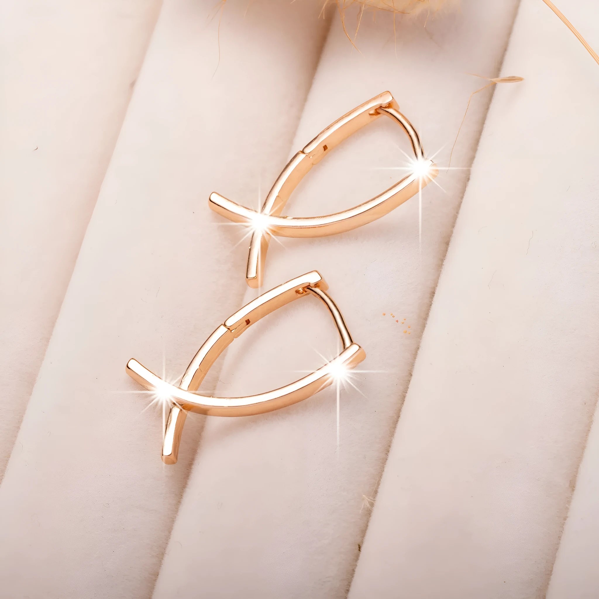 Rose gold cross shaped earrings made from copper with geometric design