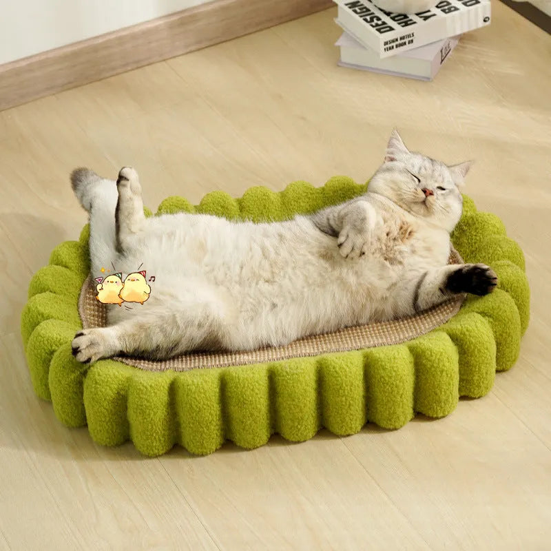 Green oval-shaped sisal cat scratching pad lounge bed on a floor.