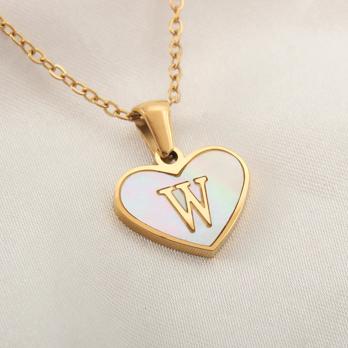 Gold plated initial necklace with white shell heart pendant and adjustable chain