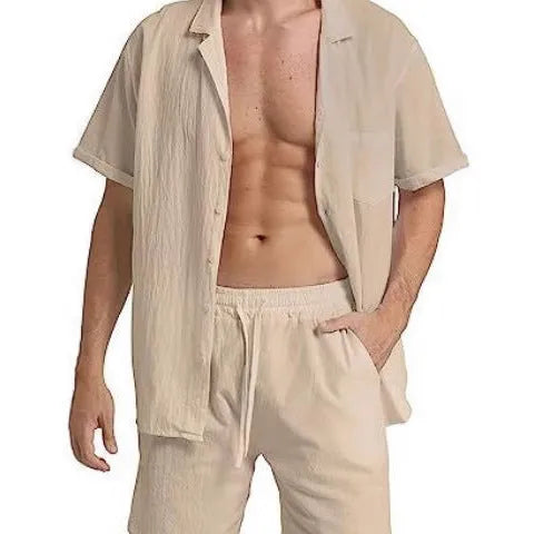 Man wearing a light grey short-sleeved Flax top and matching shorts from a summer sports suit set.