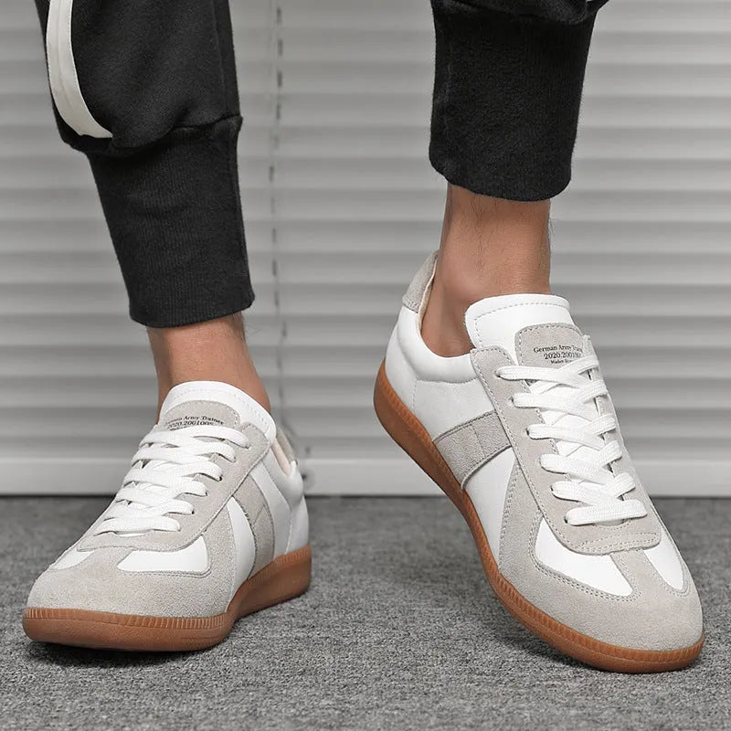 White Japanese retro low-top sneakers with matte finish and visible stitching on a rubber sole.