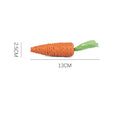 Bundle of cat toys including carrot-shaped chews, crinkly paper rings, and audible ringing stones in multiple sizes