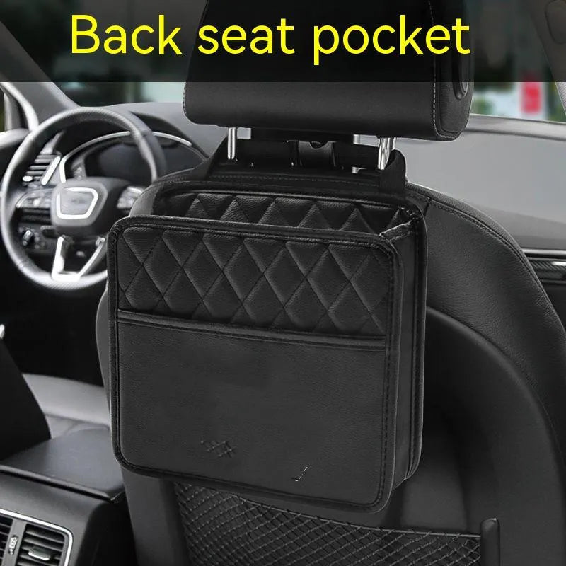 Black leather hanging storage bag for car interior, shown mounted on a headrest.