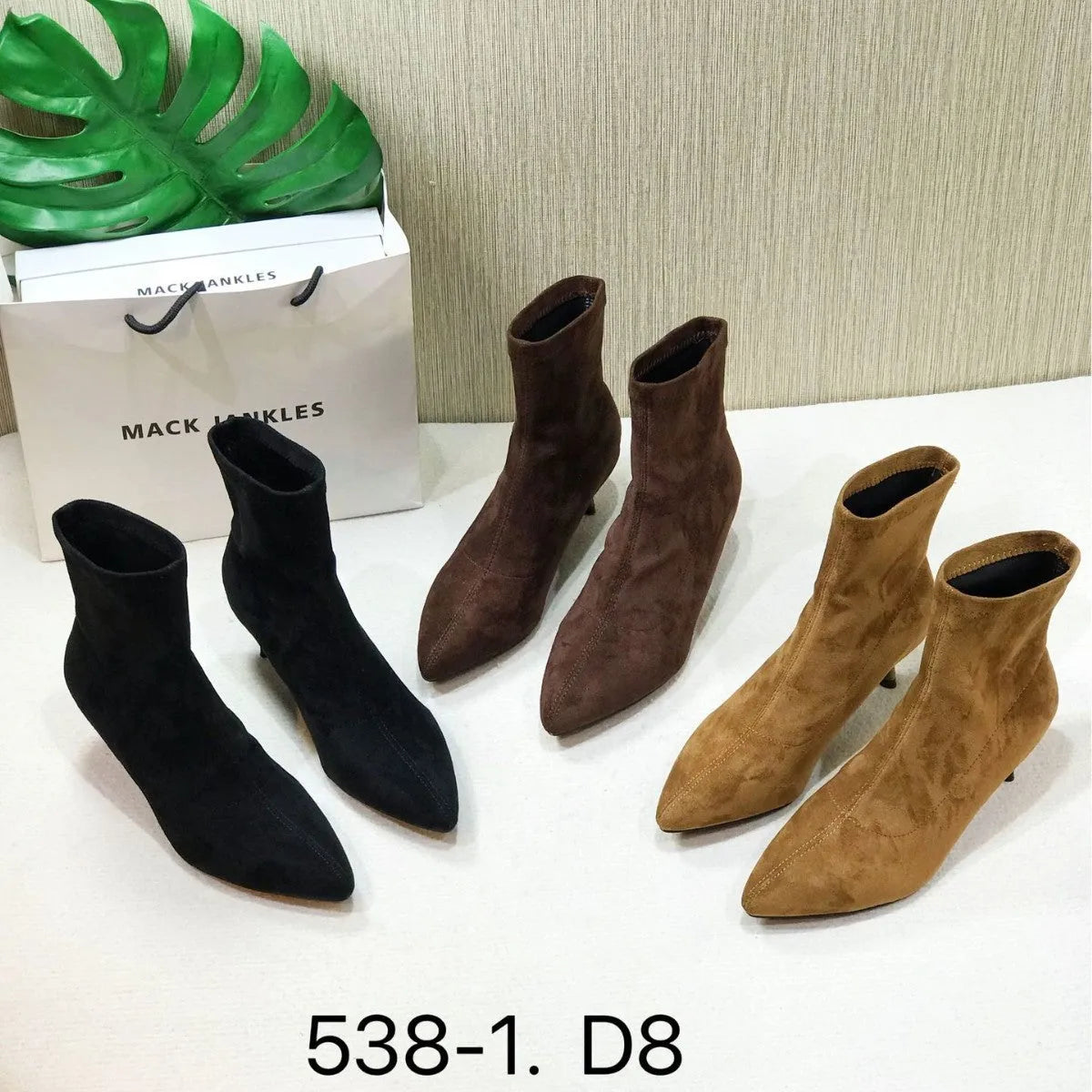 Women's black pointed toe ankle boots with stiletto heels and mid-calf length