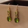 A pair of green geometric copper earrings with a quadrilateral shape in a retro bohemian style.