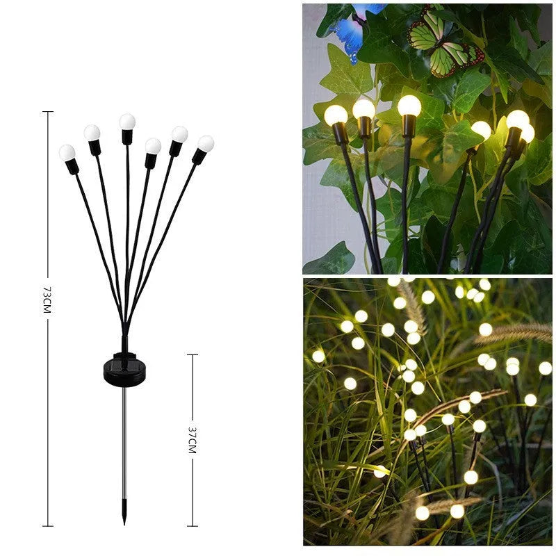 Solar-powered LED ground lamp with multiple heads inserted in garden soil alongside pathway