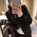 Women's grey dot knitted cardigan with long sleeves and crocheted flower detail