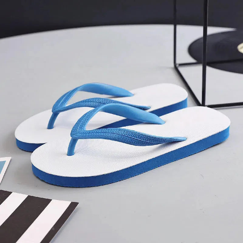 A pair of casual flip-flops with a rubber sole, shown in one of four colours (green, red, blue, or black) featuring a distinctive fish label graphic.