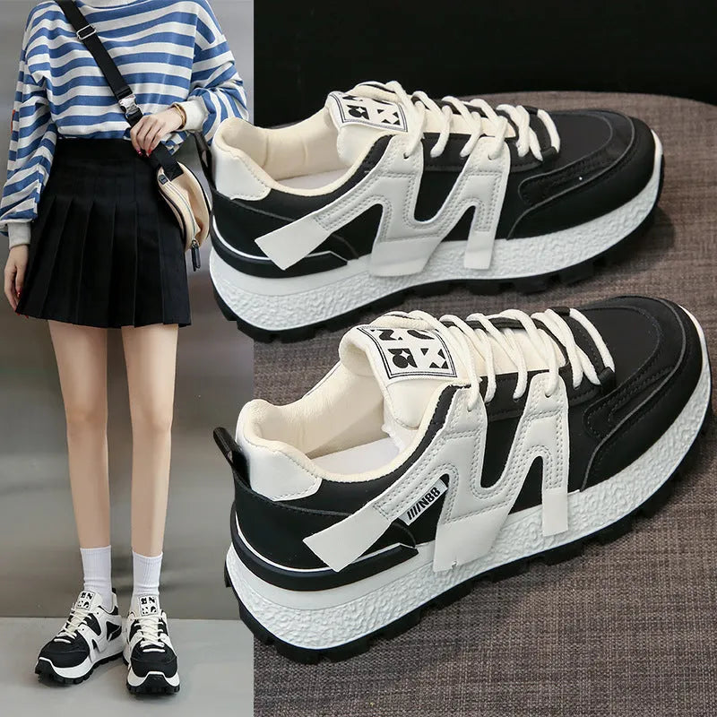 Women's white low-top running sneakers with round toe and lace-up closure on rubber sole