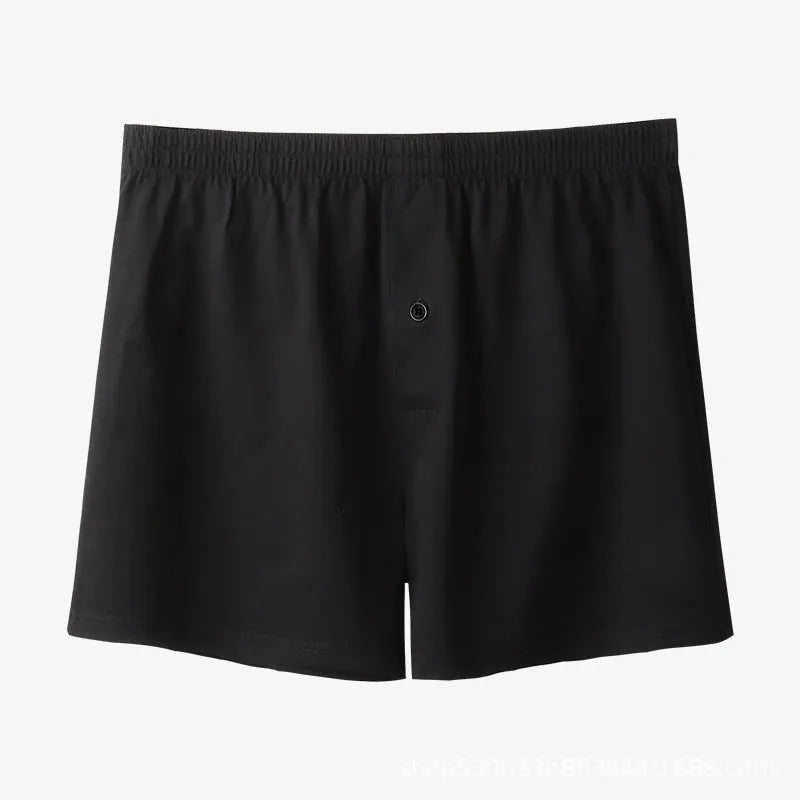 Men's solid colour cotton boxer shorts with a high waist and loose fit on a neutral background.