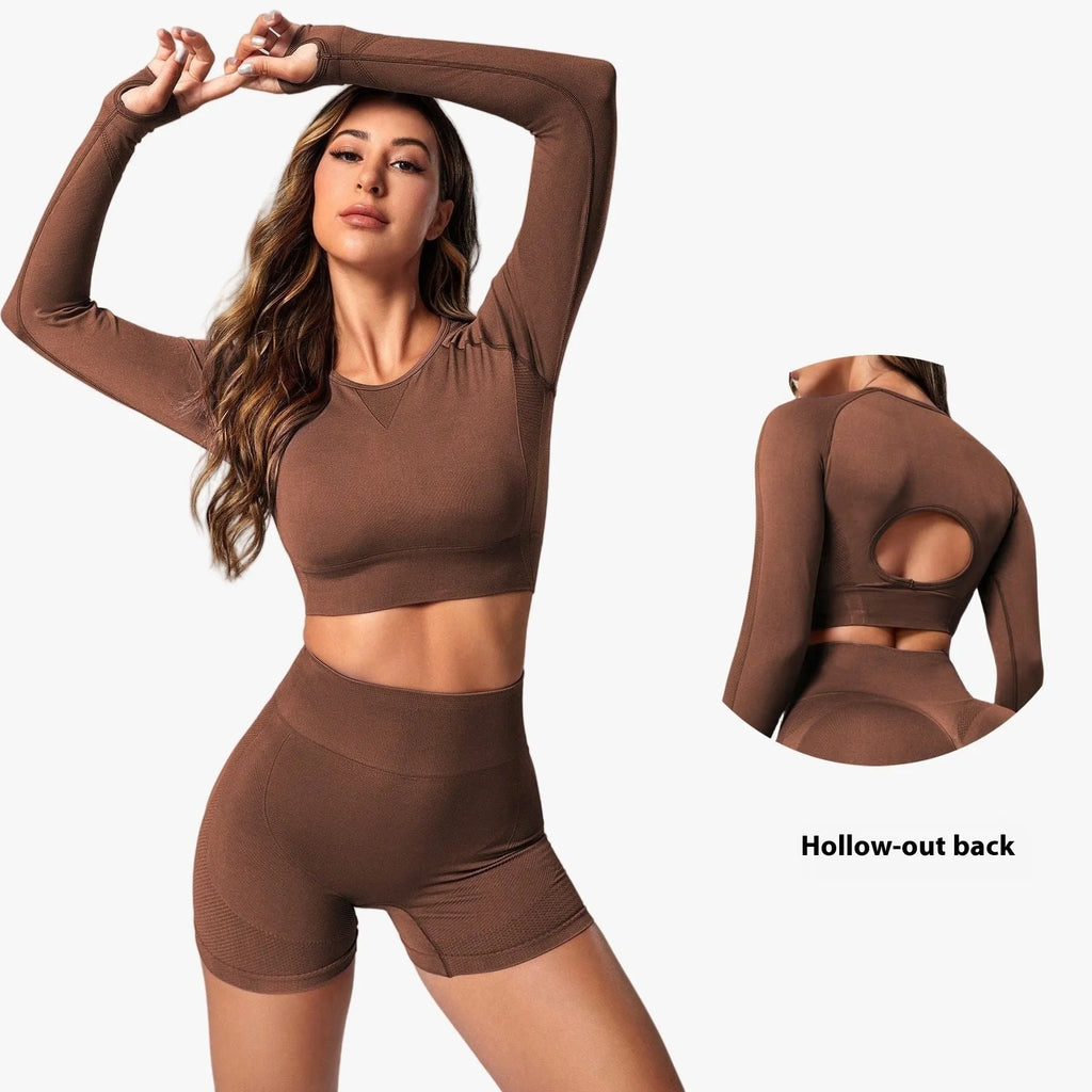 Women's black yoga suit set showing long sleeve pullover top and high-waisted tight-fitting pants.