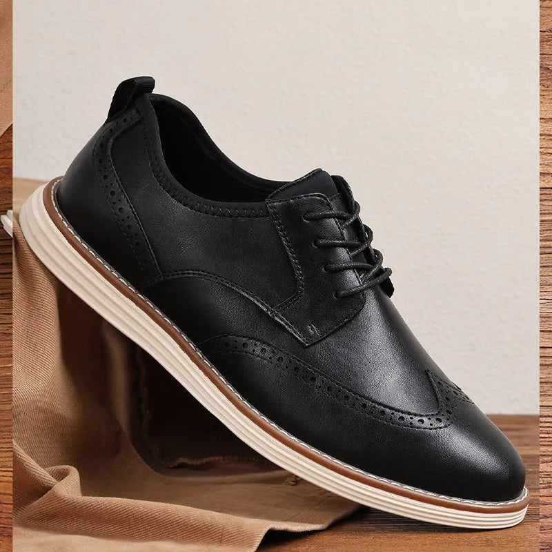 Men's black slip-on business casual shoes with decorative carving on the PU leather upper