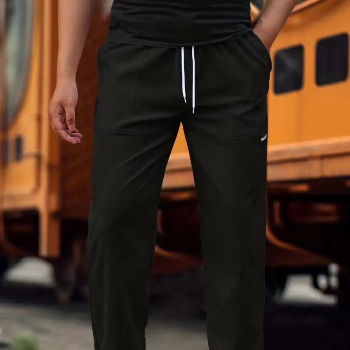 Men's polyester trousers in light grey, shown flat, with a size label indicating S-XXXL range.