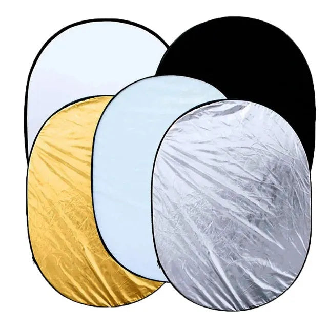 Collapsible 5-in-1 photography reflector with gold, silver, white, black, and translucent surfaces folded with carrying bag