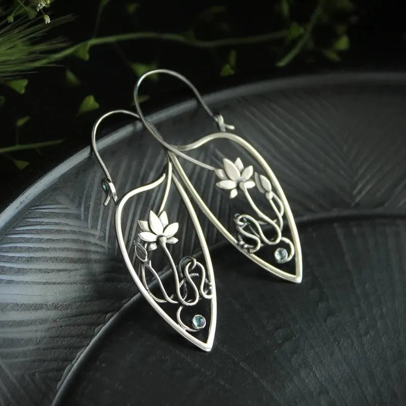 A pair of silver women's earrings with a lotus vine and geometric design featuring round rhinestones.