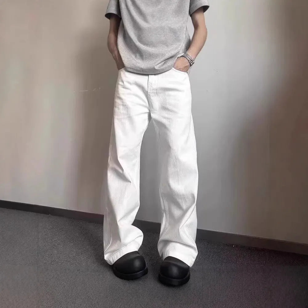 Men's white straight-leg cotton denim jeans on a plain background.
