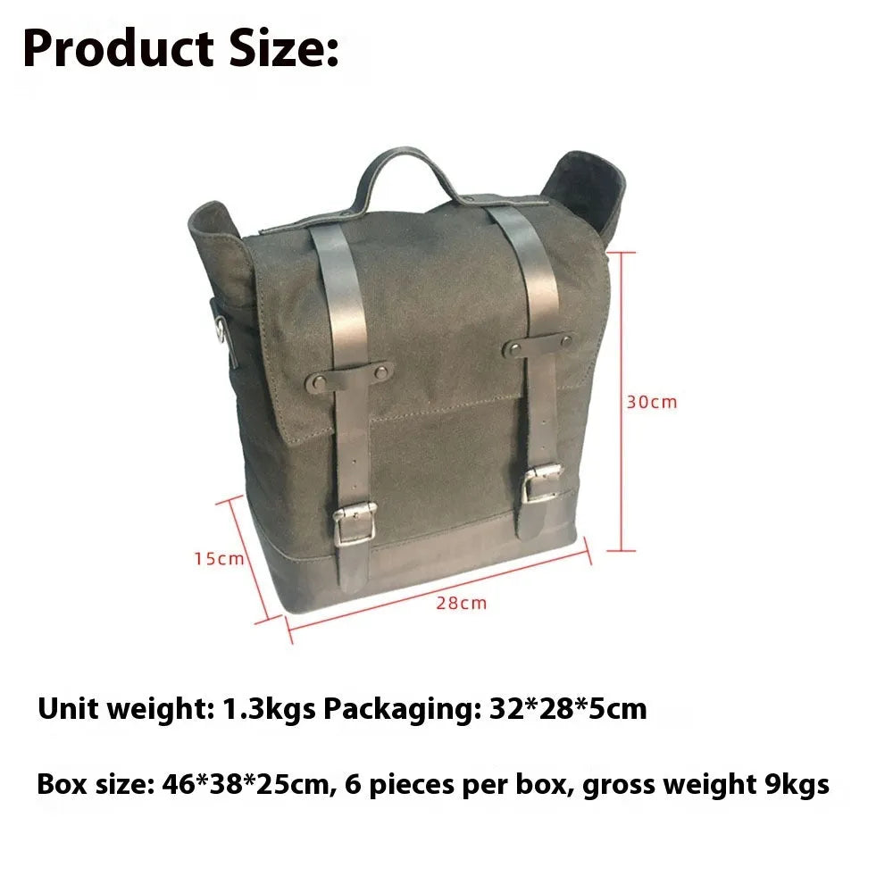 Black waterproof canvas motorcycle side pannier bag with cowhide detailing showing mounted position on bike