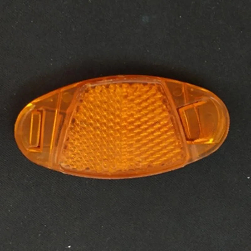 White and yellow plastic bicycle reflector spoke decorations showing 7.2cm length and 3.5cm width dimensions