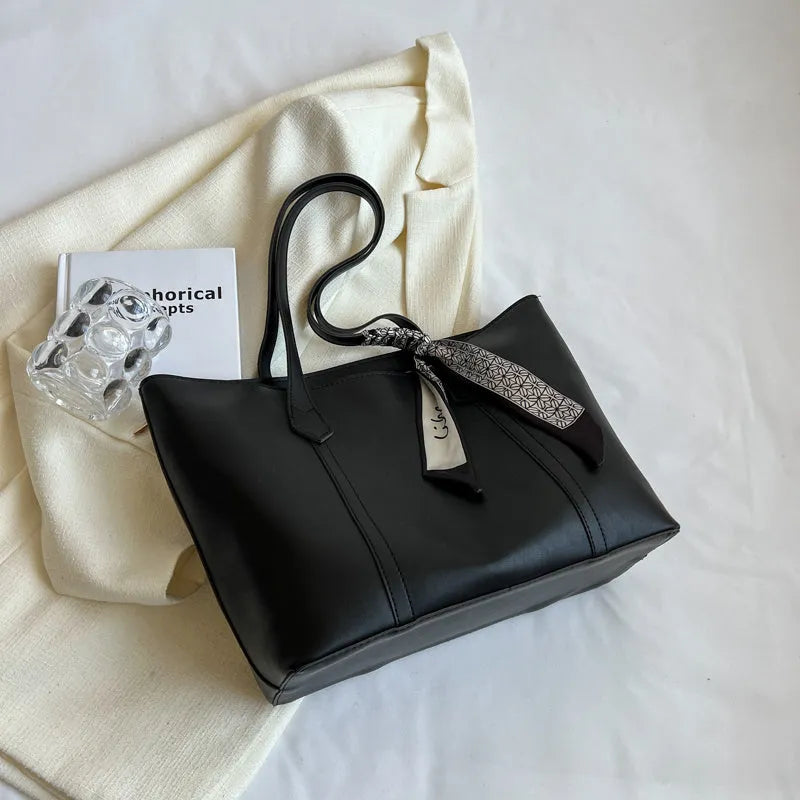 Women's soft large capacity tote bucket shoulder bag in khaki colour showing crossbody strap and front sandwich pocket.