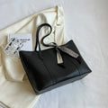 Women's soft large capacity tote bucket shoulder bag in khaki colour showing crossbody strap and front sandwich pocket.