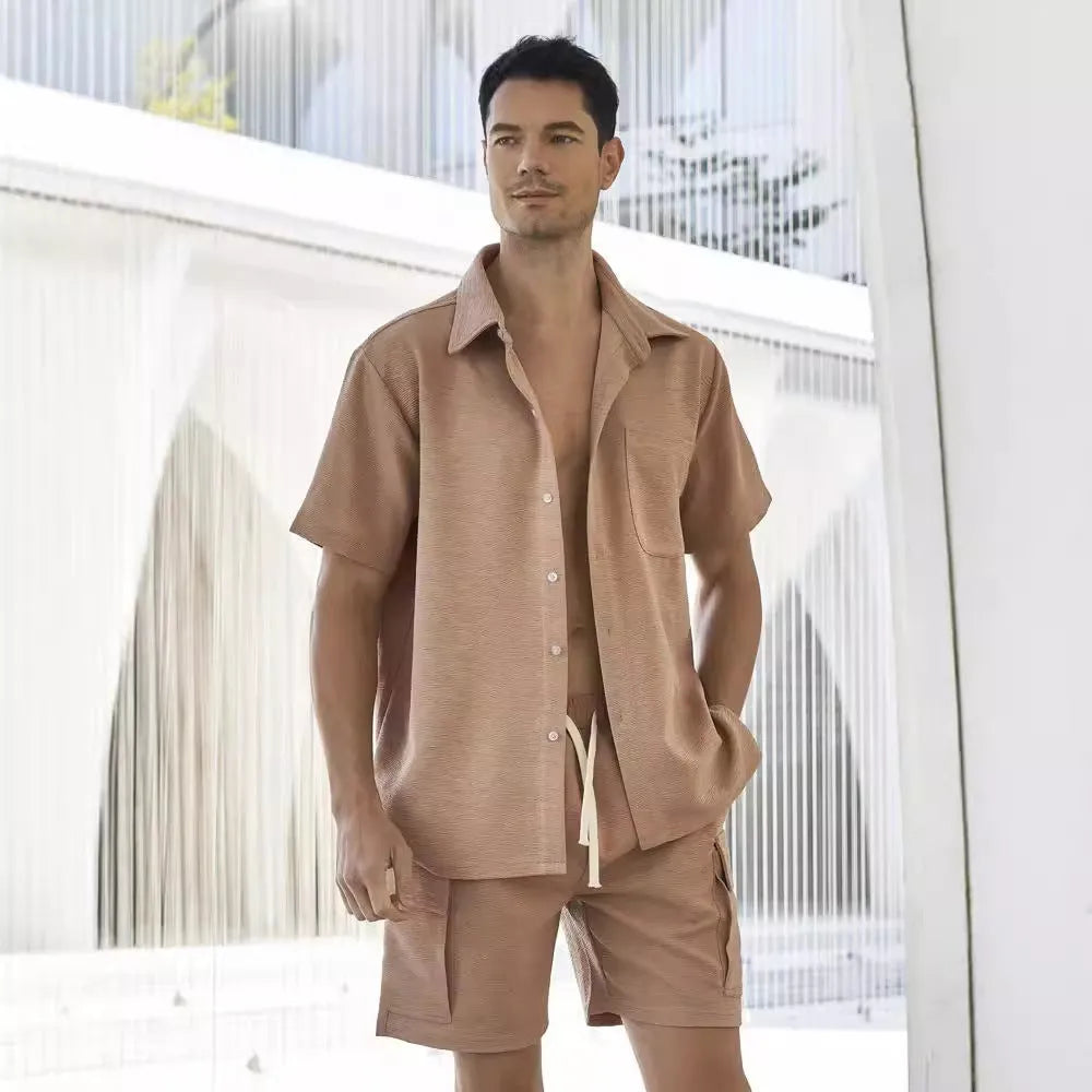 Beige elastic waist shorts and short sleeve top two-piece set laid flat.