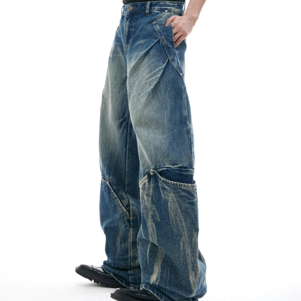Men's verdant blue loose-fit jeans with a washed burst pattern and curved knife design.