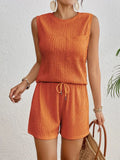 Women's apricot polyester sleeveless vest and matching shorts set laid flat