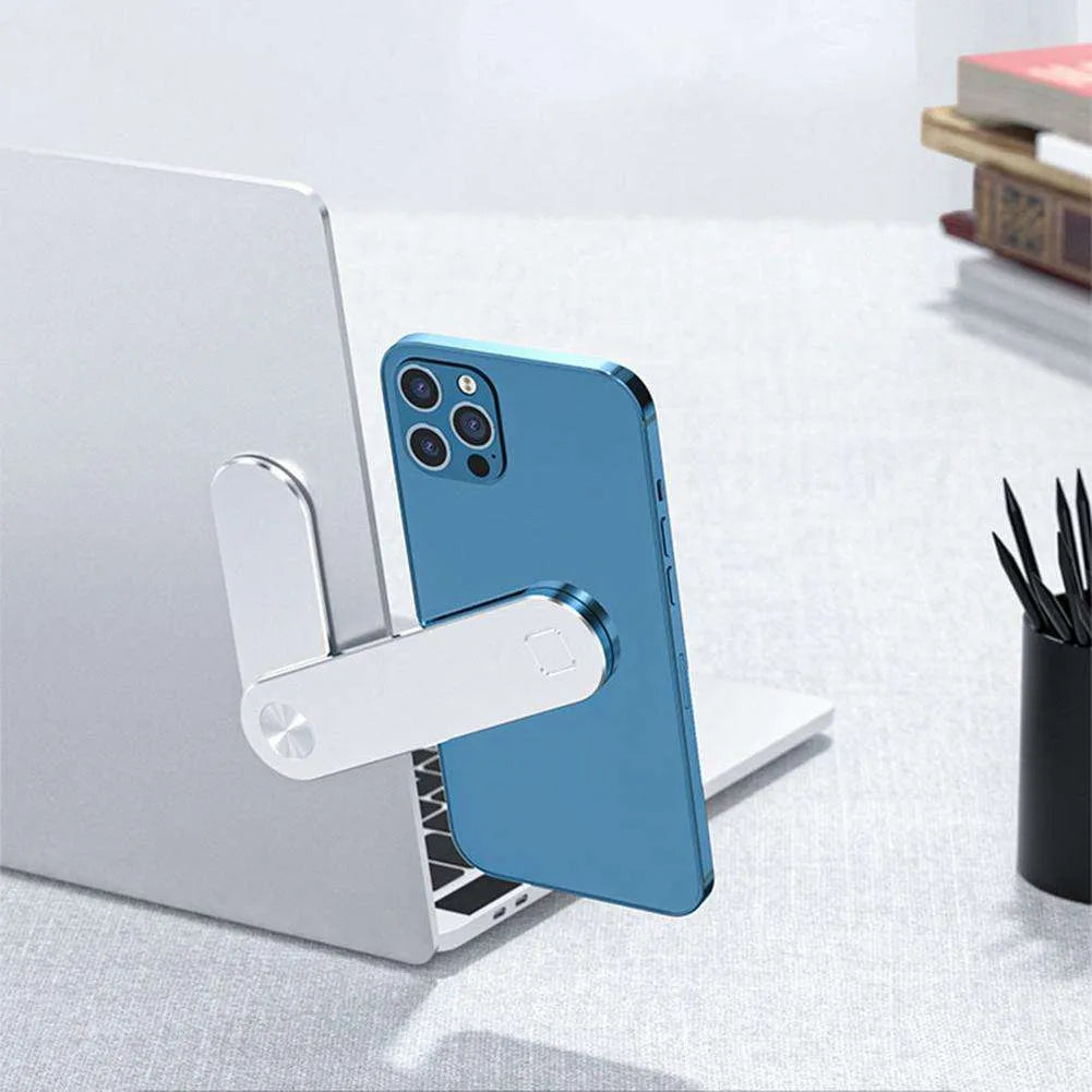 Black aluminum laptop phone holder mounted beside computer monitor showing smartphone attachment
