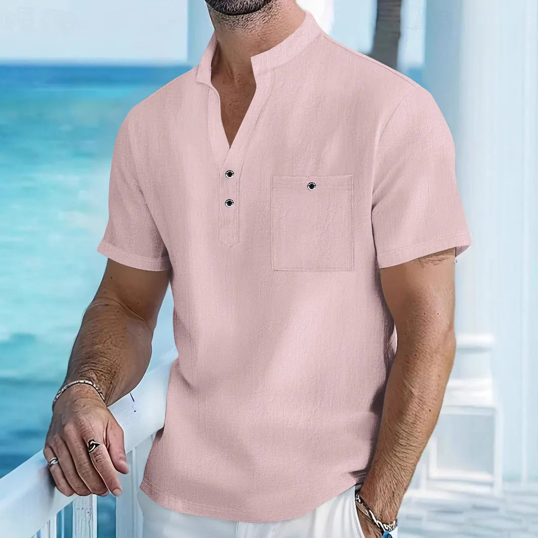 Man's light blue linen blend t-shirt with stand collar and short sleeves in a loose fit.