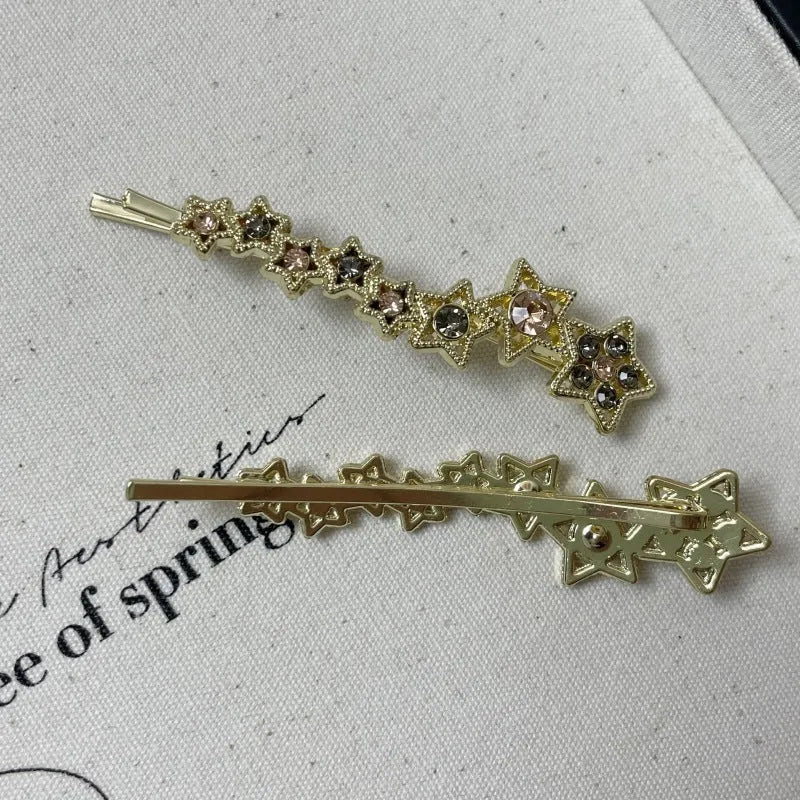 Gold electroplated rhinestone barrette with star design and side clip for bangs