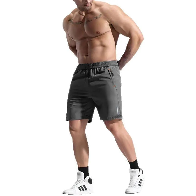 Men's grey elastic waist sports shorts made from polyester and bamboo fibre fabric on a man running outdoors.