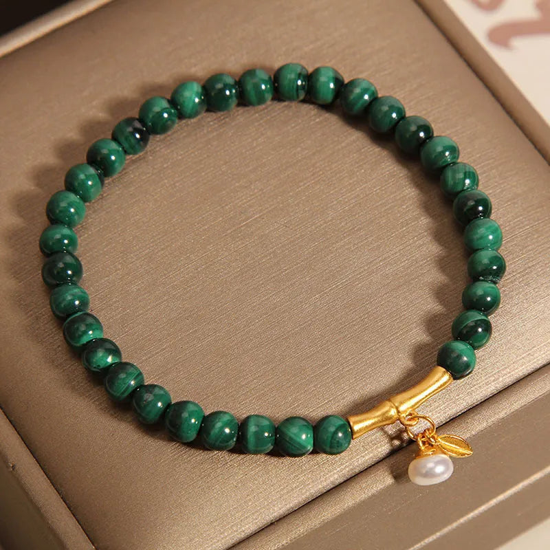 Women's white crystal bracelet with bamboo charm on adjustable metallic chain showing length between 20-24cm