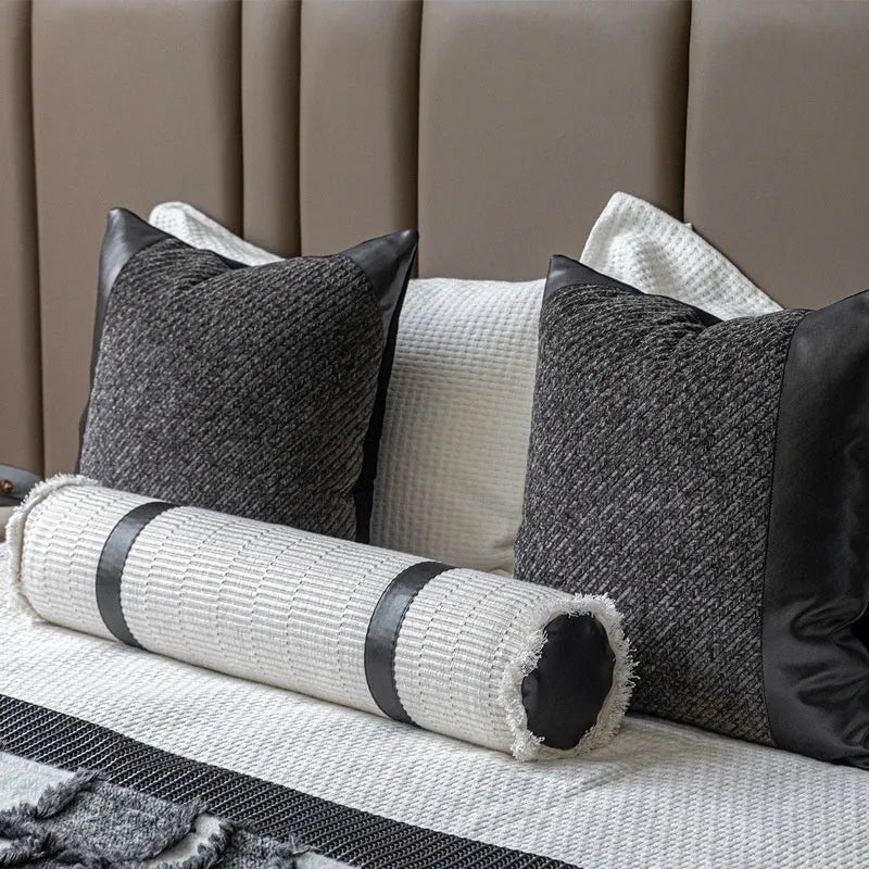 Modern minimalist grey and white plaid bed runner blanket with matching pillowcase and round leather pillow