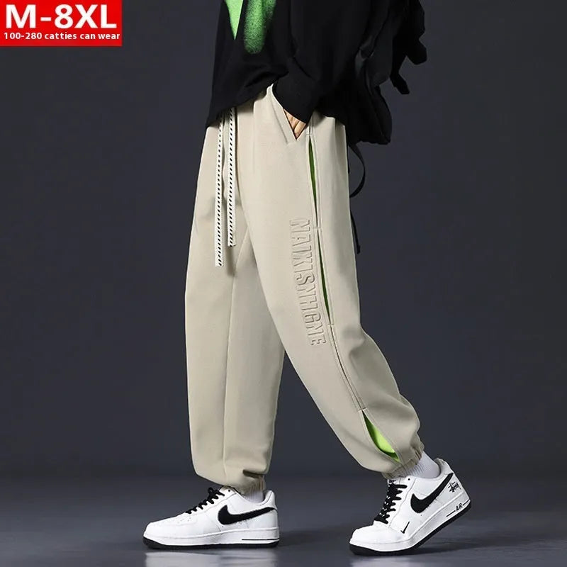 Men's loose-fit ankle banded cotton trousers with stitching detailing and skinny leg opening in grey green colour