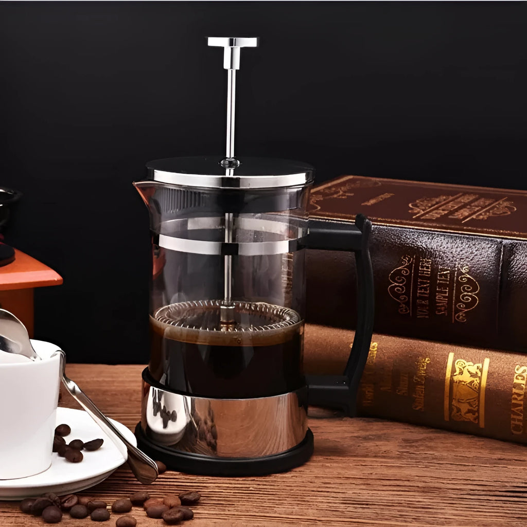 Compact glass stovetop coffee maker with stainless steel components, shown with dimensions 10cm wide and 17cm high.
